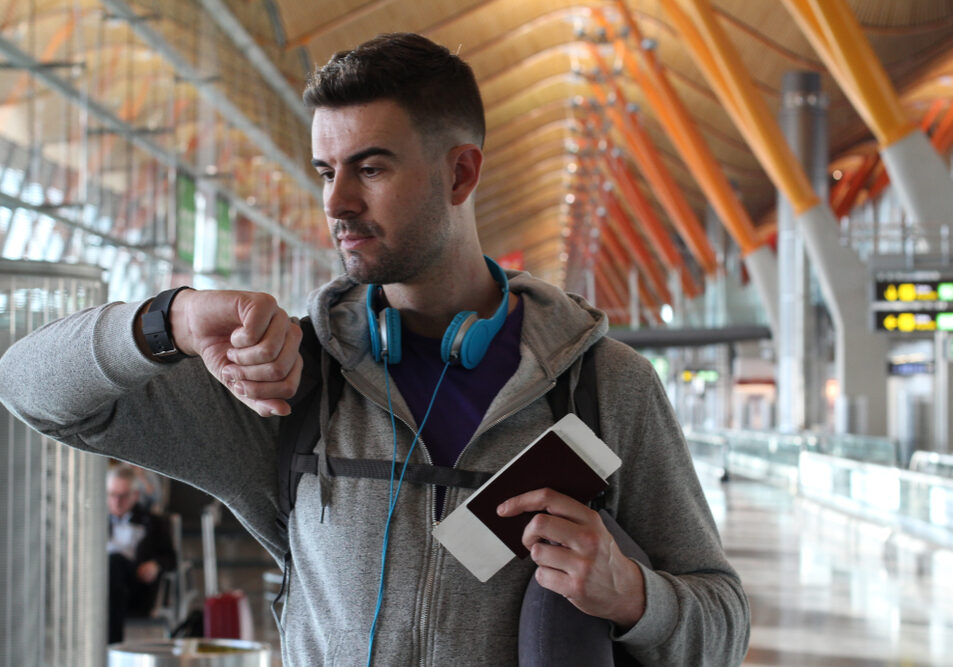 Traveler,Checking,The,Time,At,The,Airport