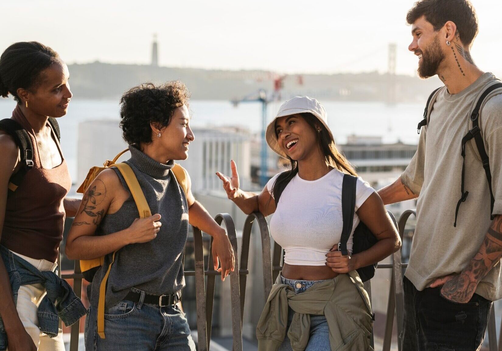 group of friends talking, overlooking the city of Lisbon and the river Tejo
