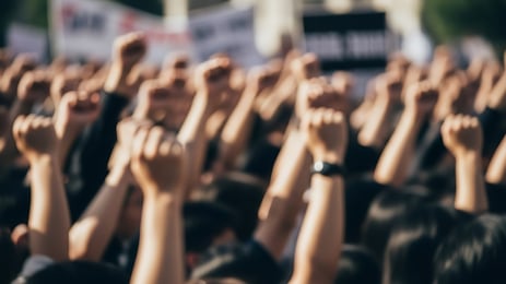 blurry photograph of people raising their hands